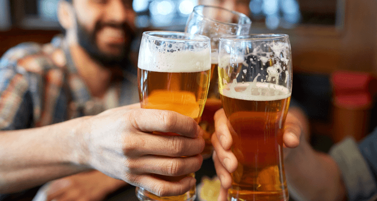 friends holding up beers